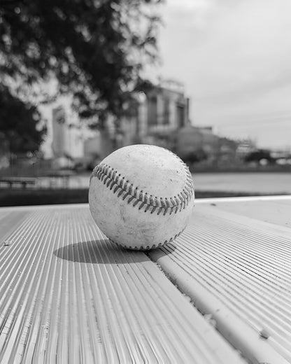 Baseball on Metal Bench