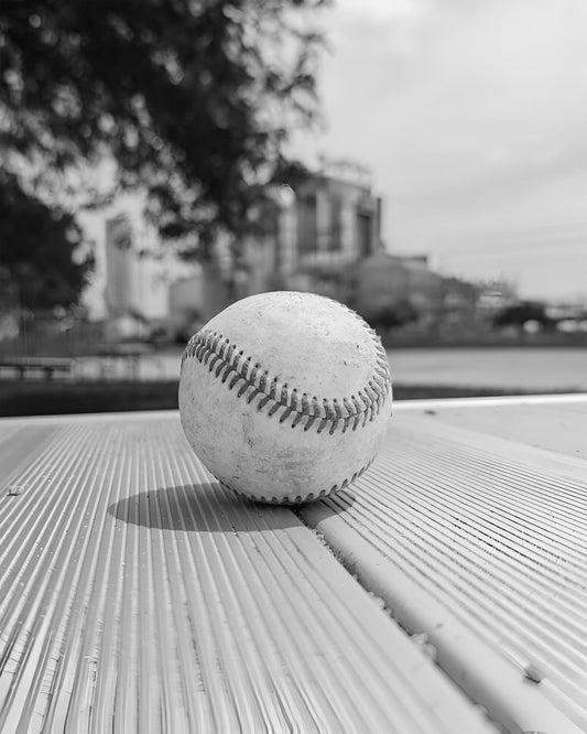 Baseball on Metal Bench
