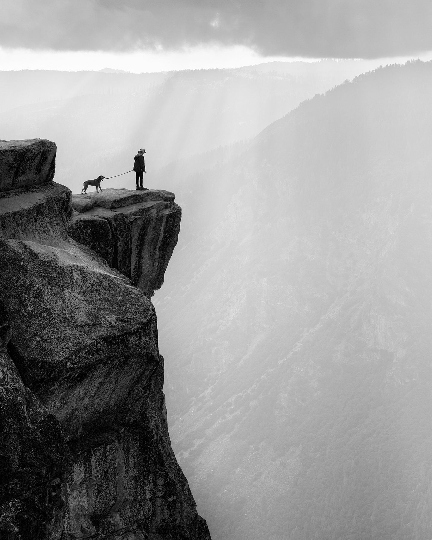 Woman And Dog On Cliff