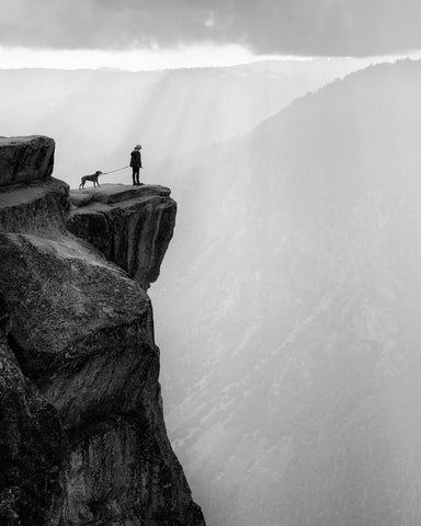 Woman And Dog On Cliff
