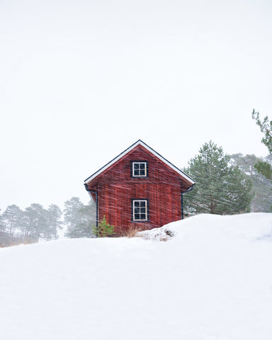 Old Red House During Snowstorm