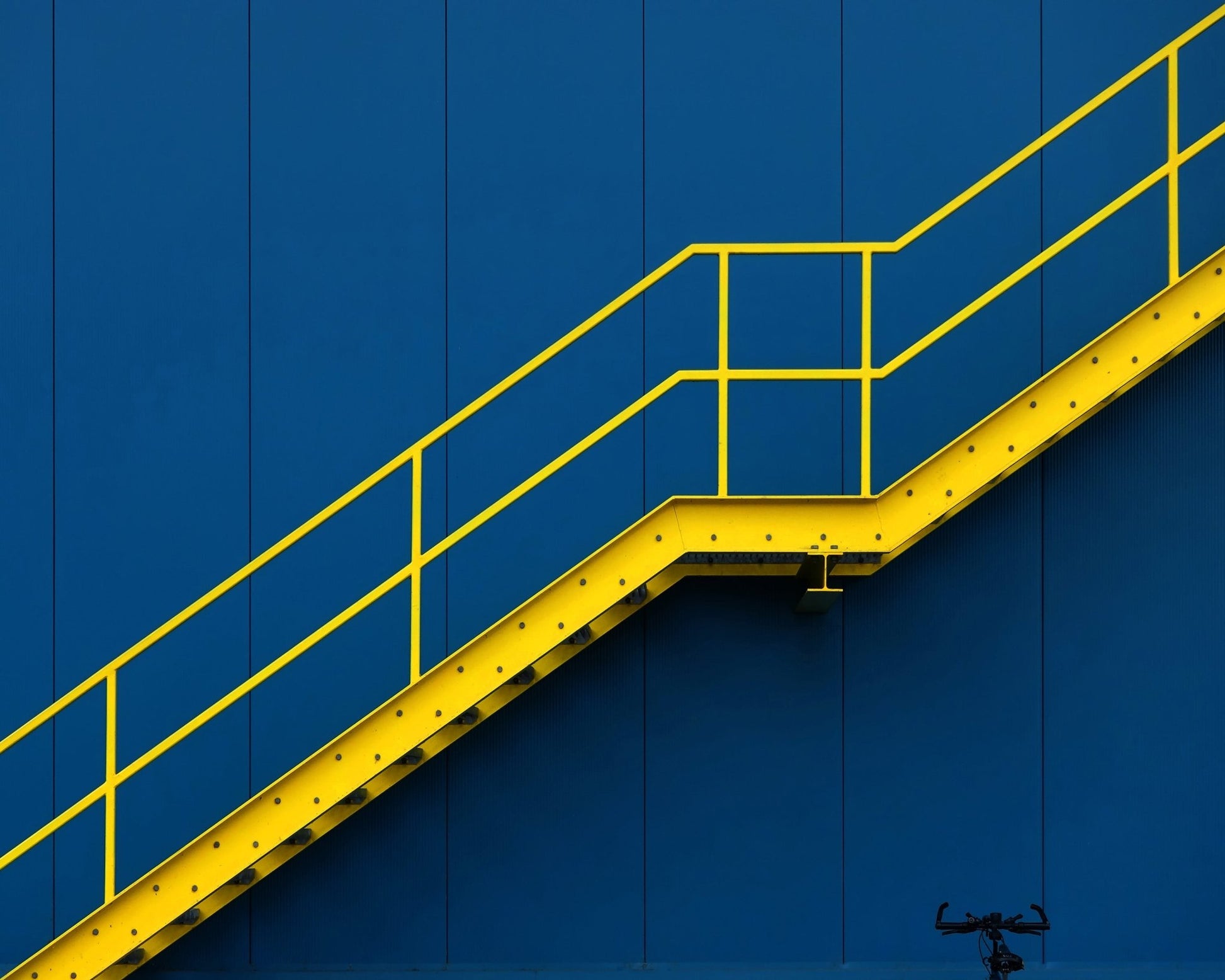 Yellow Metal Staircase Against A Blue