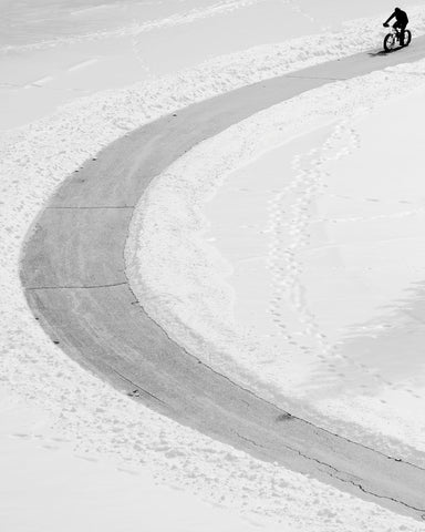 Lone Cyclist in Snow
