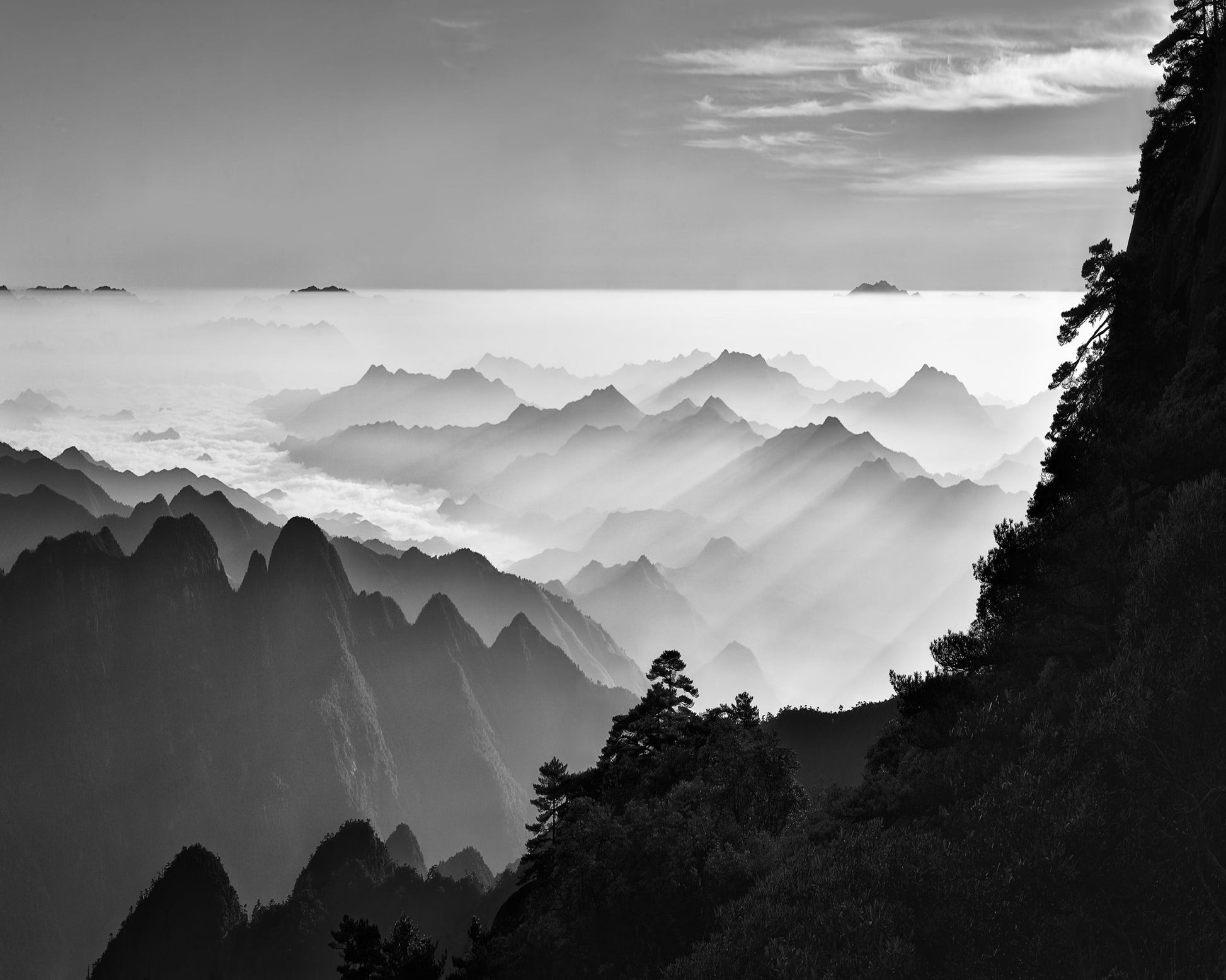 Sunrise Rays Over Mountain Peaks