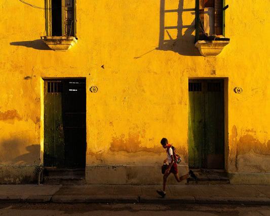 Boy Running Past Wall